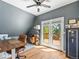 Stylish home office with hardwood floors, ample desk space, and outdoor access to a deck at 4348 Umatilla St, Denver, CO 80211