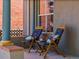 Inviting porch with two chairs, pillows, and a small table providing a comfortable outdoor living space at 4348 Umatilla St, Denver, CO 80211