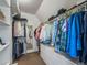 Spacious walk-in closet with built-in shelving, hanging rods, and a full-length mirror at 4348 Umatilla St, Denver, CO 80211