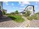 Backyard showcasing a lush lawn, stone landscaping, wood fence, and a view of the home's exterior at 8261 Garden City Ave, Littleton, CO 80125