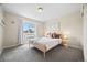 Comfortable bedroom features a window seat and neutral decor at 8261 Garden City Ave, Littleton, CO 80125