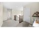 Upstairs hallway features carpet, and access to several rooms at 8261 Garden City Ave, Littleton, CO 80125