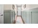 Bright hallway with wainscoting, wood floors, and a white front door at 8261 Garden City Ave, Littleton, CO 80125