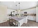 Spacious kitchen with stainless steel appliances, a large island, and modern lighting at 8261 Garden City Ave, Littleton, CO 80125