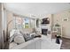 Cozy living room with a fireplace, stylish decor, and plenty of natural light at 8261 Garden City Ave, Littleton, CO 80125