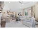 Bright and open living room featuring modern furnishings and a seamless flow to the dining area at 8261 Garden City Ave, Littleton, CO 80125
