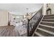 Open living space with stairs, modern rug, and flowing to the kitchen and dining room at 8261 Garden City Ave, Littleton, CO 80125