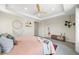 Bedroom features tray ceiling, boho decor, and a comfortable bed at 8261 Garden City Ave, Littleton, CO 80125