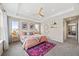 Bedroom features tray ceiling, multiple windows, and decorative rug at 8261 Garden City Ave, Littleton, CO 80125