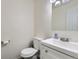 Clean half bathroom featuring a modern sink, vanity, and toilet at 5712 S Lowell Blvd, Littleton, CO 80123