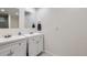Bright bathroom featuring double sinks and white cabinets at 5712 S Lowell Blvd, Littleton, CO 80123