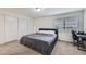 Cozy bedroom with neutral carpet, closet, and natural light from the window at 5712 S Lowell Blvd, Littleton, CO 80123