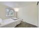 Simple bedroom featuring neutral carpet and natural light from the window at 5712 S Lowell Blvd, Littleton, CO 80123