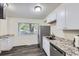 Updated kitchen with stainless steel appliances, granite countertops, and a window at 5712 S Lowell Blvd, Littleton, CO 80123
