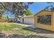 A large backyard with a pergola, patio furniture, grass, and a detached storage building at 13483 Achilles Dr, Lone Tree, CO 80124