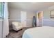 Cozy bedroom featuring plush carpet, neutral walls, and a comfortable accent chair near the window at 13483 Achilles Dr, Lone Tree, CO 80124