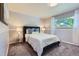 Comfortable bedroom featuring a full-size bed, soft carpet, and a window with natural light at 13483 Achilles Dr, Lone Tree, CO 80124