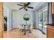 Cozy dining area featuring a round glass table, white chairs, ceiling fan, and sliding glass door at 13483 Achilles Dr, Lone Tree, CO 80124