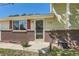 Close-up shot of the home's entrance showcasing the front door and surrounding brick facade at 13483 Achilles Dr, Lone Tree, CO 80124