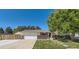 Charming two-story home with a well-maintained lawn, attached garage, and mature trees providing shade at 13483 Achilles Dr, Lone Tree, CO 80124