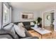 Bright living room with a comfortable sectional sofa, modern decor, and a large mirror at 13483 Achilles Dr, Lone Tree, CO 80124
