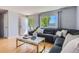 Inviting living room with a gray sectional, modern coffee table, and natural light from the front door at 13483 Achilles Dr, Lone Tree, CO 80124