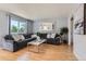 Spacious living room featuring a plush gray sectional, stylish coffee table, and plenty of natural light at 13483 Achilles Dr, Lone Tree, CO 80124