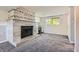 Living room featuring a decorative fireplace, plush carpet, and natural light at 13483 Achilles Dr, Lone Tree, CO 80124
