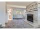 Spacious living room featuring a decorative fireplace, and a glimpse into the neighboring spaces at 13483 Achilles Dr, Lone Tree, CO 80124