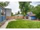 Expansive backyard featuring a well-kept lawn, patio area, and charming shed, offering ample space for relaxation and activities at 3525 N Alcott St, Denver, CO 80211