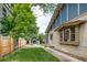 Beautiful backyard showcasing a well-maintained lawn, patio area, charming shed, and lush greenery at 3525 N Alcott St, Denver, CO 80211