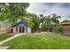 Well-manicured backyard with a charming blue shed, lush lawn, and inviting patio area, perfect for outdoor enjoyment at 3525 N Alcott St, Denver, CO 80211