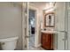 Bathroom featuring dark wood vanity, shower, and toilet at 3525 N Alcott St, Denver, CO 80211