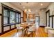 Dining room with view to kitchen, updated lighting, and hardwood floors at 3525 N Alcott St, Denver, CO 80211