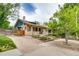Exterior view showcasing the brick facade, driveway, and landscaped front yard at 3525 N Alcott St, Denver, CO 80211