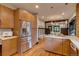Open kitchen with stainless steel appliances and a view to dining area at 3525 N Alcott St, Denver, CO 80211