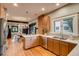 Bright kitchen with stainless steel appliances, a brick feature, and an open concept view to the dining area at 3525 N Alcott St, Denver, CO 80211