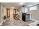 Finished basement kitchenette featuring stainless steel appliances and open shelving at 3525 N Alcott St, Denver, CO 80211