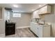 Well-lit kitchenette with white cabinets and stainless steel appliances at 3525 N Alcott St, Denver, CO 80211