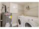 Laundry area with a washing machine, dryer, and water heater at 3525 N Alcott St, Denver, CO 80211