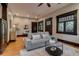 Bright living room with hardwood floors, gray couch, and neutral decor at 3525 N Alcott St, Denver, CO 80211