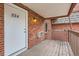 Balcony featuring brick walls and wooden planks. Unit number 224 can be seen at 5491 E Warren Ave # 224, Denver, CO 80222