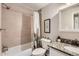 Updated bathroom featuring granite countertops, tiled shower with cactus curtain, and modern fixtures at 5491 E Warren Ave # 224, Denver, CO 80222