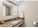 Bathroom with granite countertops, a modern faucet and towel holder, and a well-lit mirror at 5491 E Warren Ave # 224, Denver, CO 80222