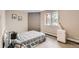 Bedroom with gray and white bedding, a window, and a portable air conditioning unit at 5491 E Warren Ave # 224, Denver, CO 80222