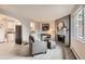 Inviting living room featuring a brick fireplace, gray sofa, and stylish decor at 5491 E Warren Ave # 224, Denver, CO 80222