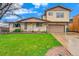 Inviting home featuring a well-maintained lawn, classic brickwork, and a cozy covered porch at 8871 Rutgers St, Westminster, CO 80031