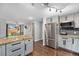 Bright kitchen features stainless steel appliances and granite countertops, open to the dining area at 8871 Rutgers St, Westminster, CO 80031