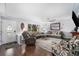 Spacious living room with hardwood floors, modern ceiling fan, and large window for ample natural light at 8871 Rutgers St, Westminster, CO 80031