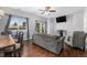 Living room featuring hardwood floors, large windows, furniture, a fan, and a television at 8871 Rutgers St, Westminster, CO 80031